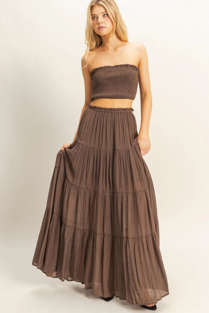 Brown smocked bandeau top and tiered maxi skirt set.