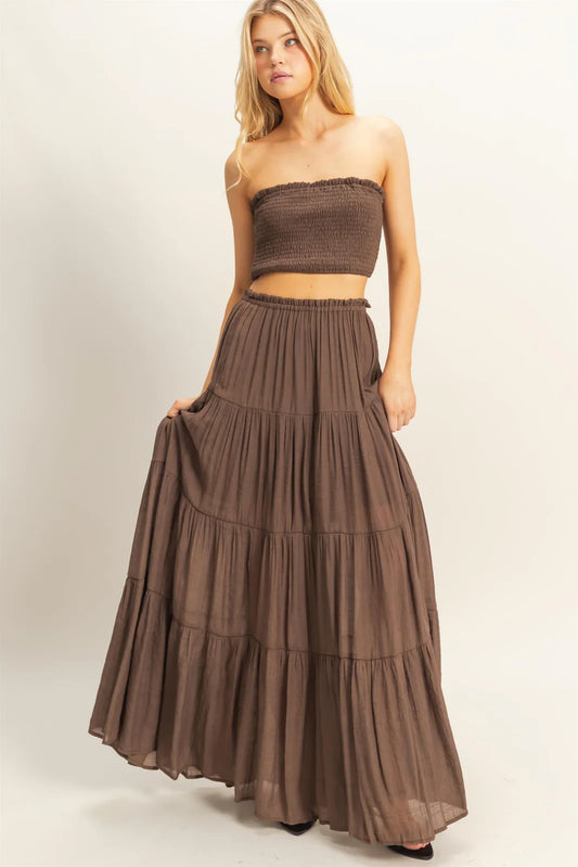 Brown smocked bandeau top and tiered maxi skirt set.