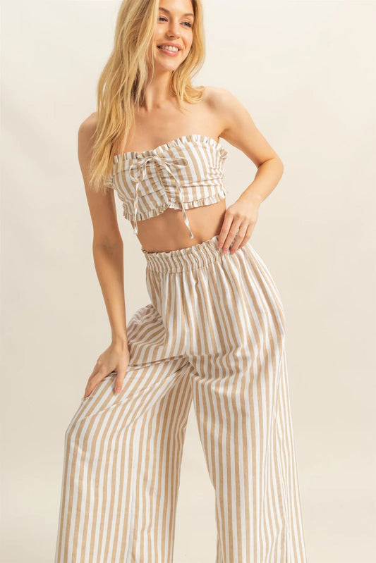 Woman in a striped crop top and wide-leg pants set.